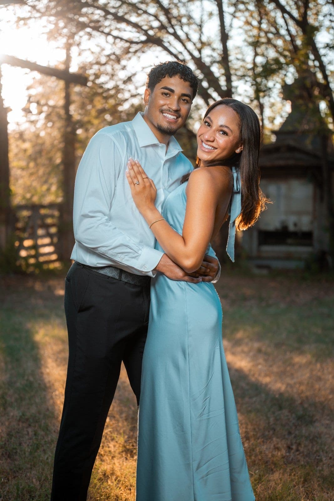 Newly engaged couple smiling together during a golden-hour outdoor engagement portrait in Austin, Texas.